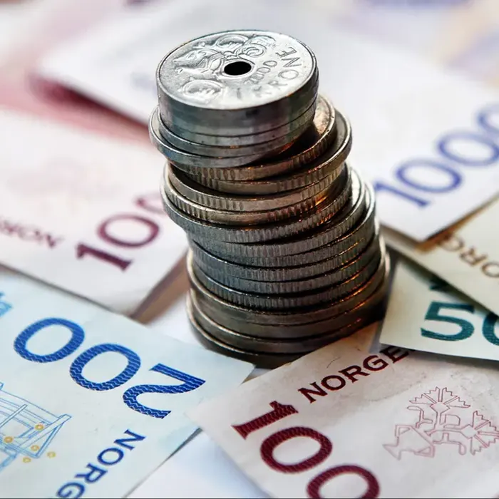 Norwegian krone currencies and stack of coins